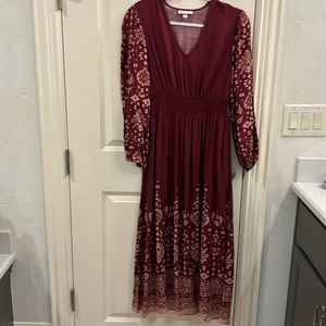 Women’s long sleeve smocked maxi dress with pockets.